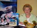 AZASTA President Hope Wallace, of ADA Travel, helps Lynn Langley at the Disney Cruise Lines table.