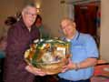 AZASTA Allied Co-Chair and Communications Director Mark Torpey, of M. H. Ross Travel Protection, presents a beautiful gift basket to a door prize winner.
