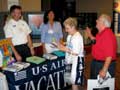 U.S. Airways Vacations representatives review Caribbean, Mexico, and Central American destinations with prospective travelers.